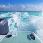 boat outboard stern with prop wash foam caribbean sea
